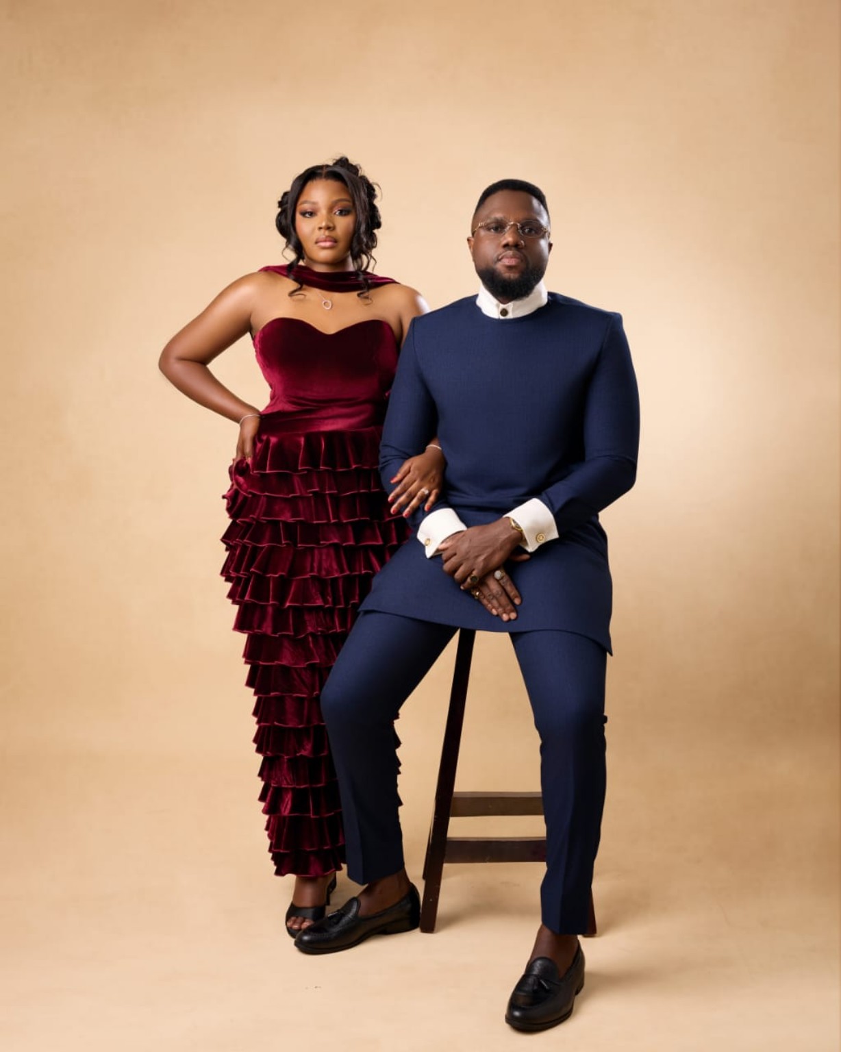 Bridget standing beside Jeffrey in their formal studio portrait